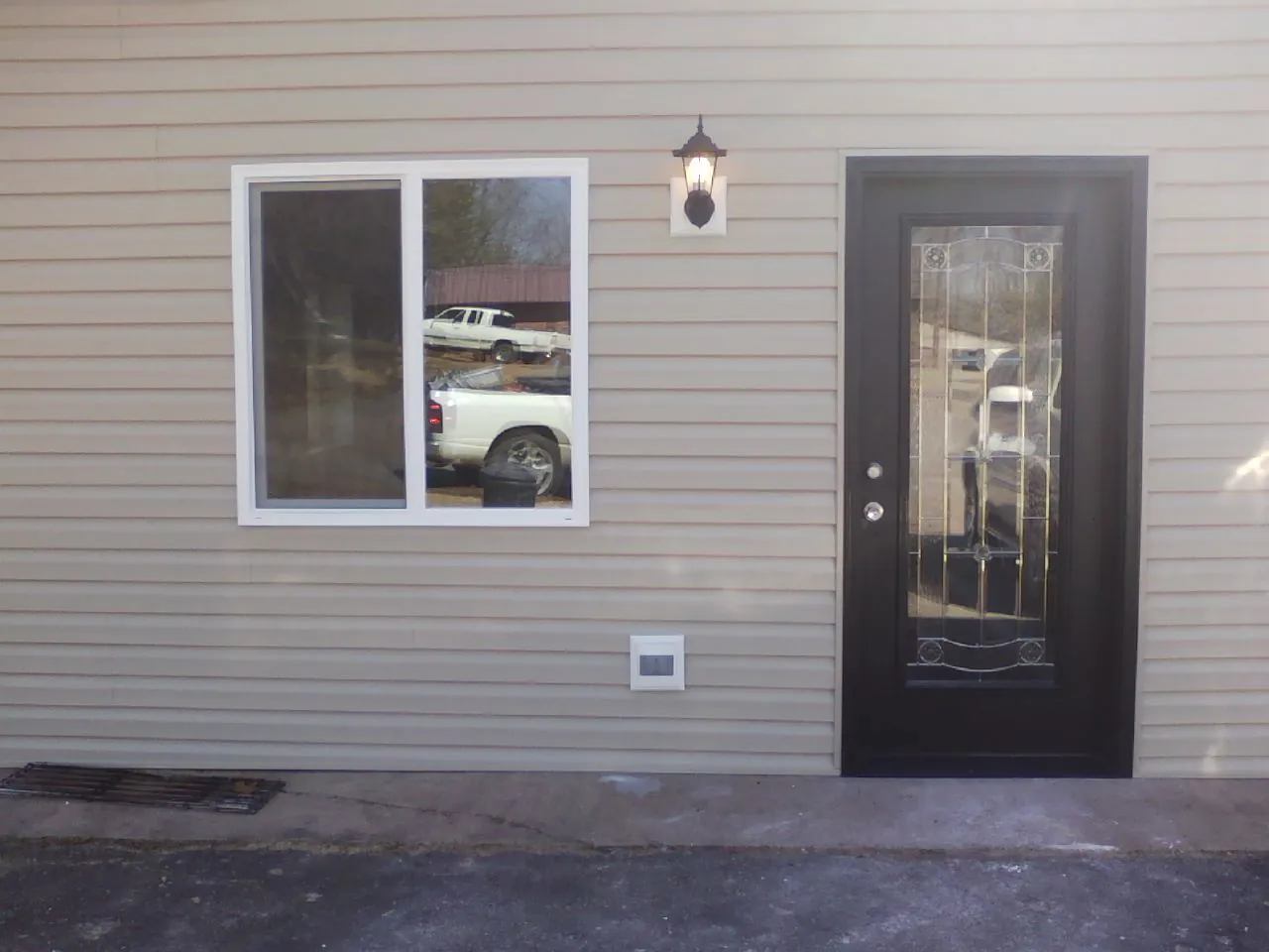 New siding, window and entry door on the side of an addition in Sharpsburg