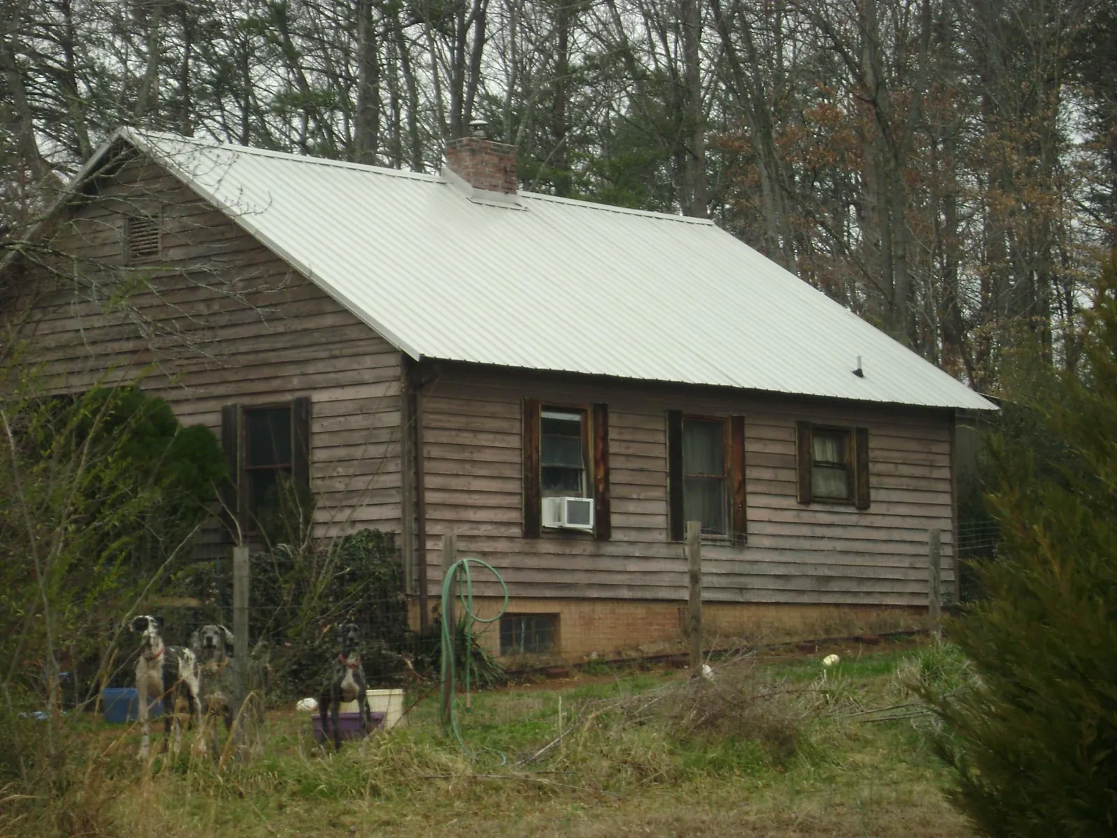White metal roof on an old wood sided farmhouse, from a Asphalt Shingle Roof Repair job in Sharpsburg